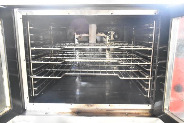 Vulcan VC6GE-SEFFCAM5 commercial stainless steel convection oven with view-through doors, metal racks, and thermostatic controls.