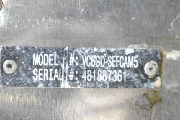 Model and serial number plate of Vulcan VC6GE-SEFFCAM5 commercial convection oven, featuring gas power and thermostatic controls.