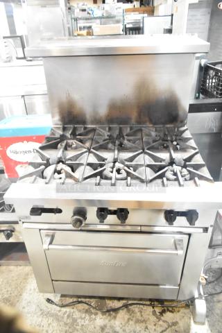 Garland SunFire commercial gas range, 6 burners, stainless steel with oven, over shelf, and backsplash, moderate wear.