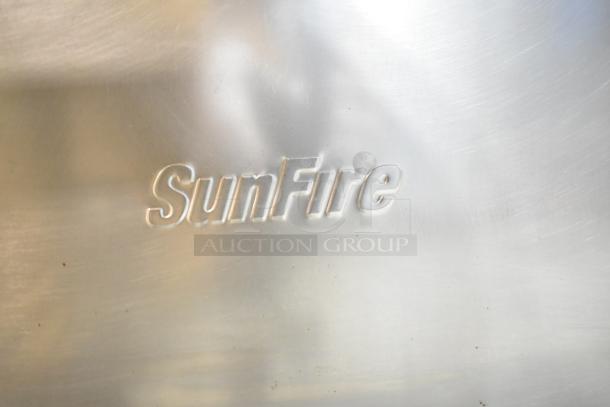 Garland SunFire logo on stainless steel surface, part of a commercial gas-powered 6 burner range with oven, over shelf, and backsplash.