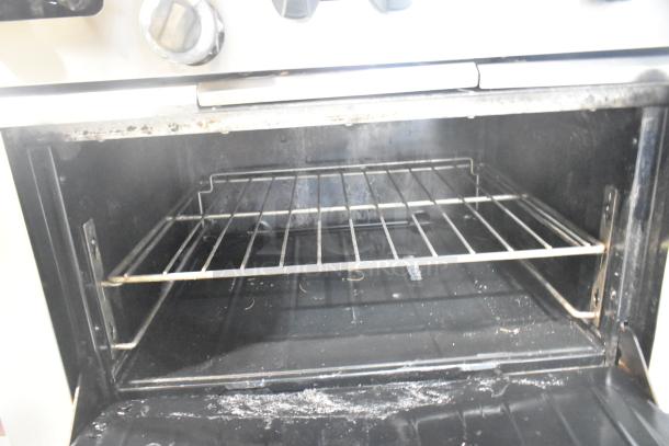Garland SunFire stainless steel gas range oven interior, showing the rack and used condition. Ideal for commercial kitchens.
