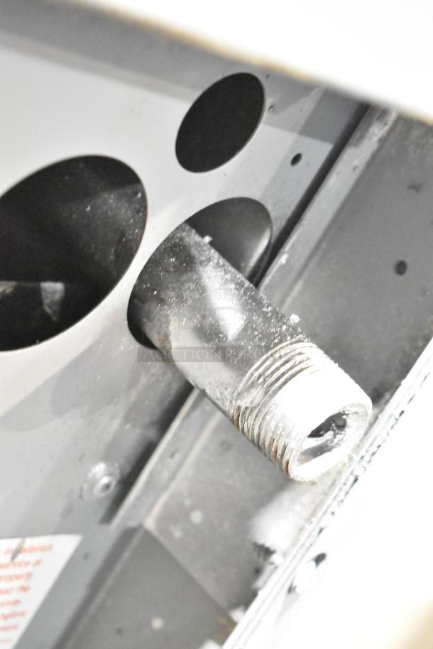 Garland SunFire commercial gas range component, showing stainless steel connection details. Condition appears worn.