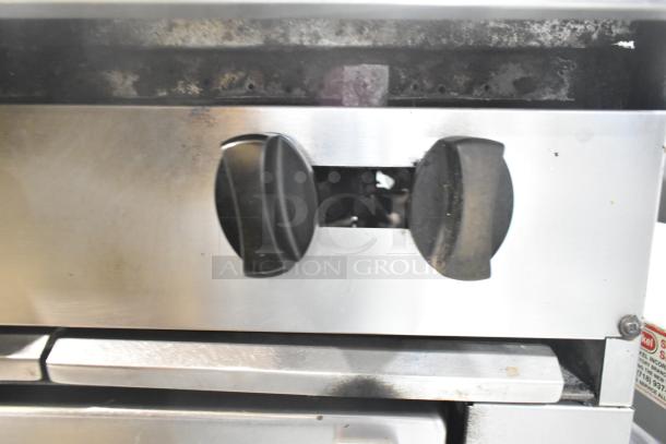 Garland SunFire Stainless Steel Gas 6 Burner Range with oven, shelf, and backsplash, control knobs shown, used condition.