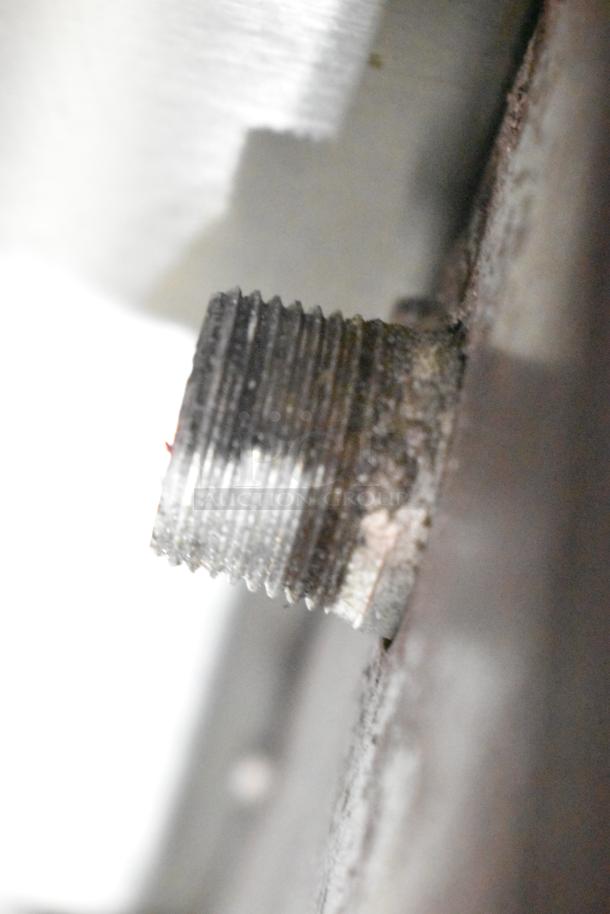 Close-up of a threaded gas inlet on a Radiance stainless steel commercial single burner stock pot range, showing moderate wear.