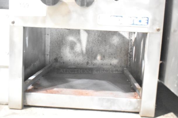 Radiance Stainless Steel Gas Single Burner Stock Pot Range, commercial, used, visible wear, sturdy build, model details on tag.