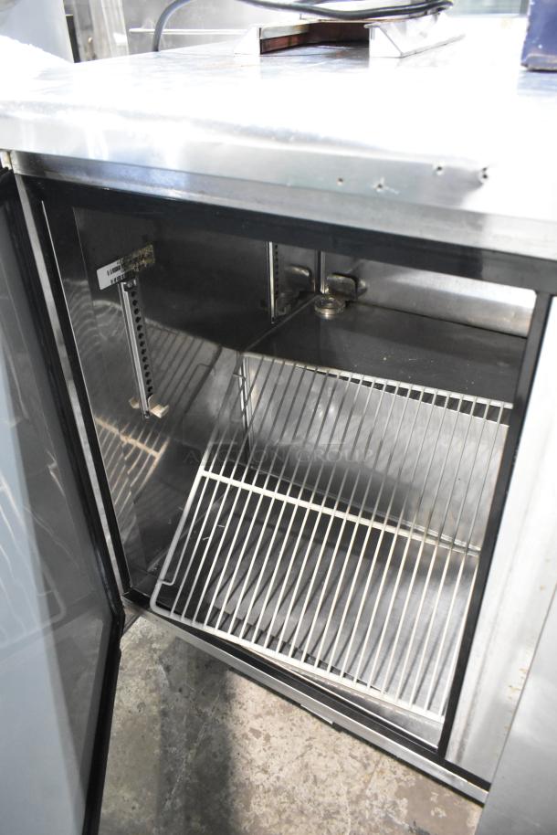 Turbo Air stainless steel commercial 3-door undercounter cooler, 115 volts, 1 phase, open door view, interior shelves visible.