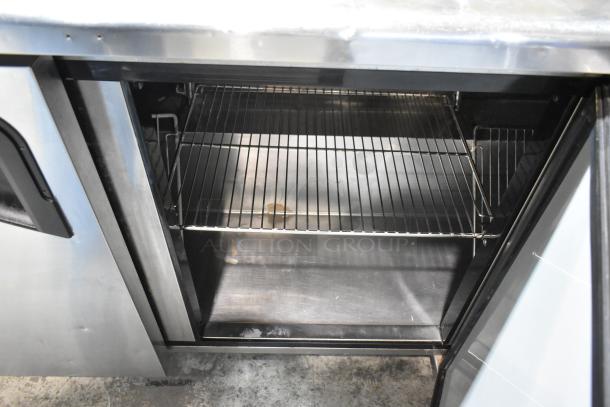 Turbo Air stainless steel 3-door undercounter cooler, 115V, 1-phase. Features adjustable shelves, used condition.