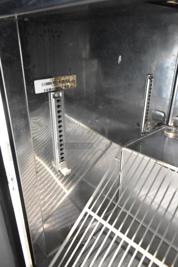 Turbo Air stainless steel 3-door undercounter cooler interior, adjustable shelves, 115V, 1 phase, commercial use.