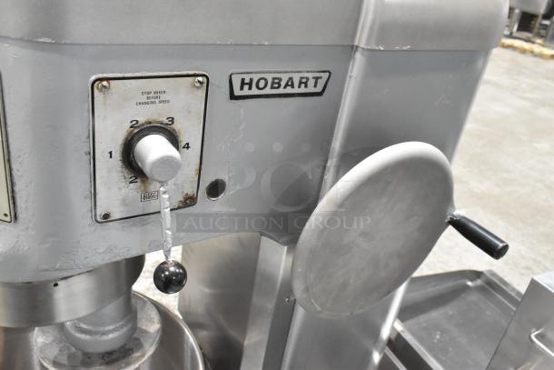 Hobart H-600 commercial 60-quart dough mixer with pelican head, bowl, and hook. Features speed dial and Hobart branding.