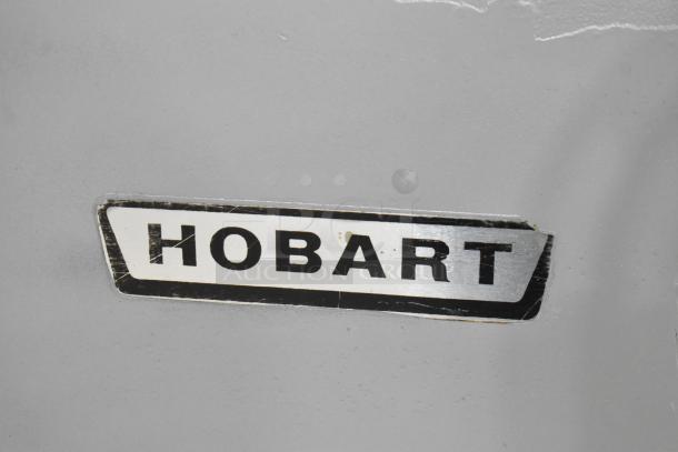 Hobart H-600 mixer label, indicating commercial-grade planetary dough mixer; includes pelican head, bowl, and hook attachment.