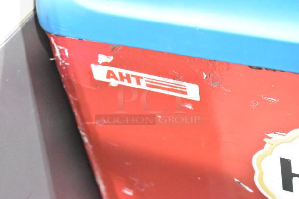 AHT commercial freezer merchandiser with visible wear, red and blue finish, AHT logo. 115 volts, 1 phase, on casters.