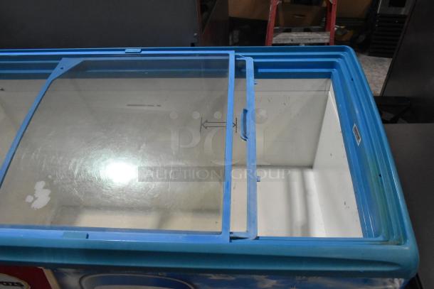 AHT metal commercial freezer merchandiser on casters with sliding glass top, 115 volts, 1 phase, blue frame, moderate wear.