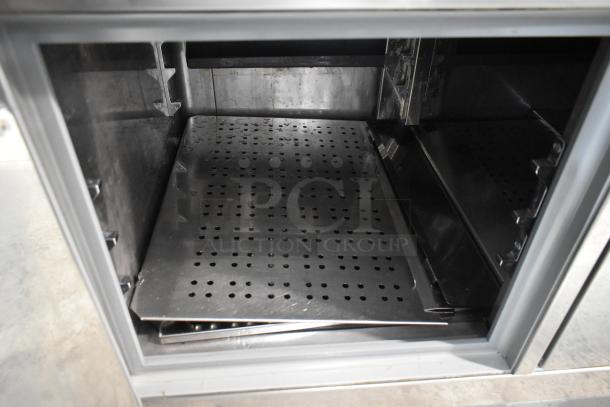 2023 ISA Tavola Fredda stainless steel commercial prep unit with refrigeration. Interior view of perforated trays. Powered at 230 volts.