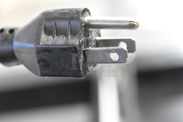 Alt text: Close-up of a black power plug for the 2023 ISA Tavola Fredda Stainless Steel Commercial Prep Unit.