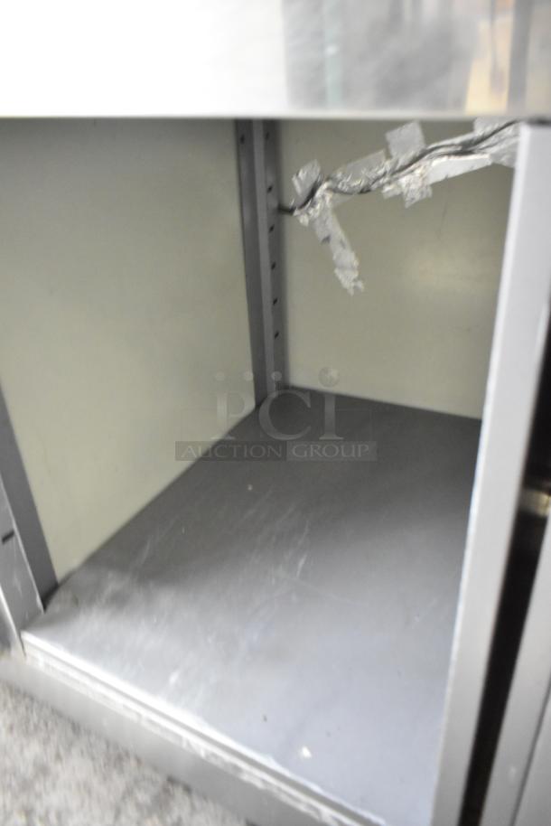 2023 ISA Tavola Fredda stainless steel commercial prep unit, open storage view, showing minor wear, 230 volts.