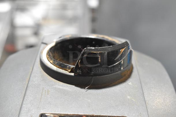 Mahlkonig Tanzania Grau espresso bean grinder, metal body, 120V, no hopper, visible wear on rim, commercial grade.