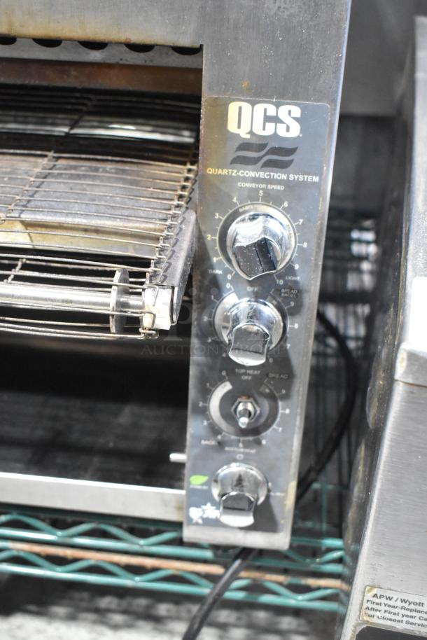 Star QCS-2-800 stainless steel commercial toaster oven with dial controls, quartz-convection system, and conveyor speed settings.