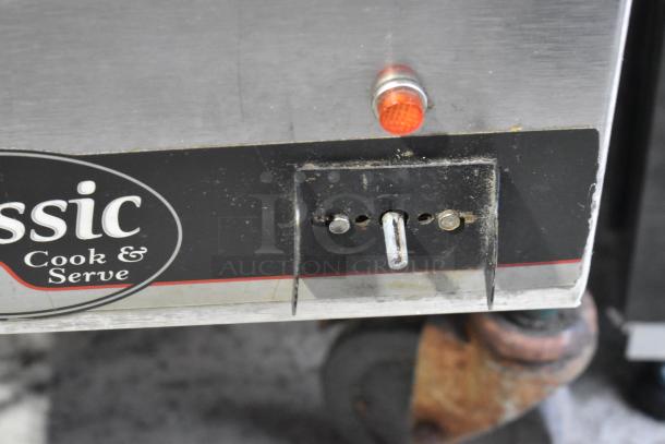 APW Wyott CW-2A stainless steel countertop food warmer, 115 volts, with visible control panel and indicator light.