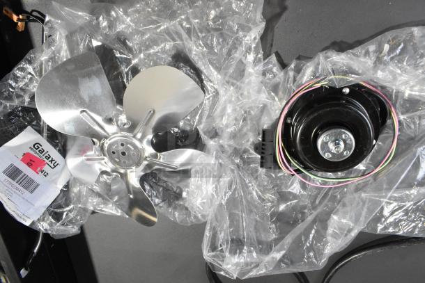 Brand new Galaxy 177PGSM412 condenser fan motor, showing metal blades and wiring, for slushy machines. Includes label.