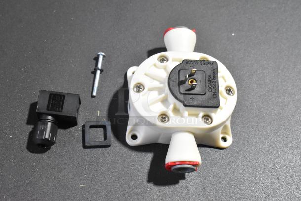 Bunn 50408.0000 Valve, Solenoid 3 Way 24VDC shown with components, new condition, Swiss made marking visible.