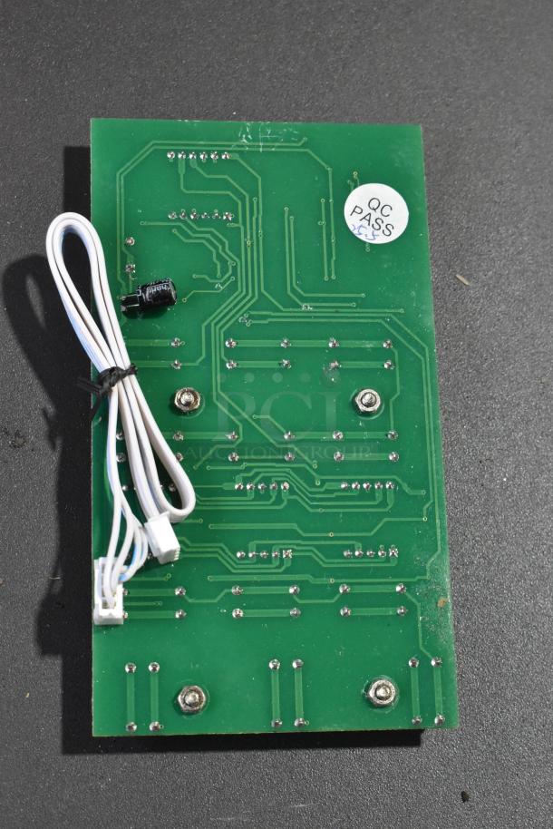 Circuit board with "QC PASS" sticker, green surface with silver components and attached white cables. Brand new condition.