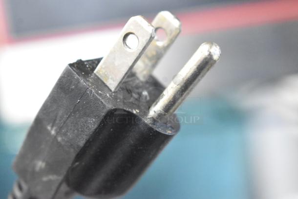 Close-up of a power plug for the Winco FW-L600 Stainless Steel Commercial Countertop Food Warmer, 120 Volts, 1 Phase.