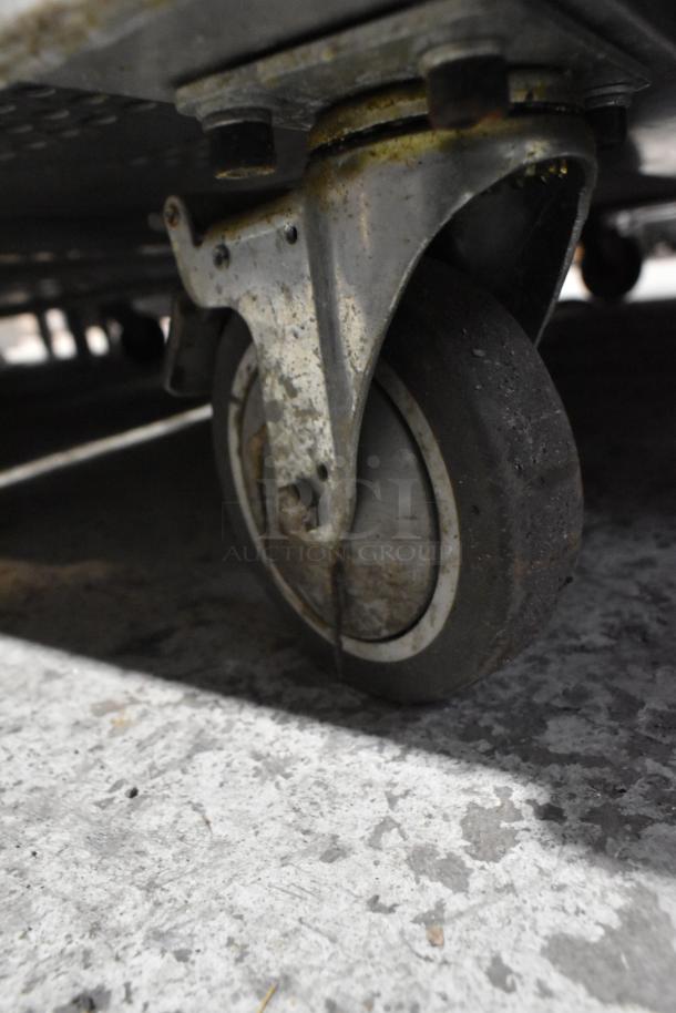 Close-up of a metal caster wheel on a 2018 Bevles HPIC-6836 heated holding cabinet showing signs of wear.