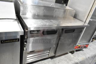 2021 Leader ESPT48 stainless steel commercial pizza prep table, with commercial casters, 115 volts, 1 phase.