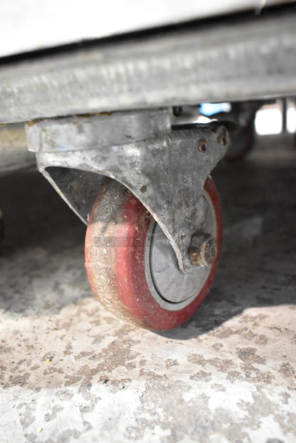 2021 Leader ESPT48 stainless steel commercial pizza prep table caster, showing condition and mobility features.