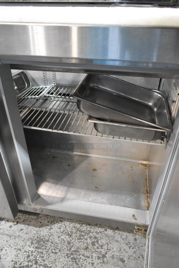 2016 Continental SW48-18M stainless steel prep table, roomy interior, wire shelving, slight wear, for commercial kitchens.