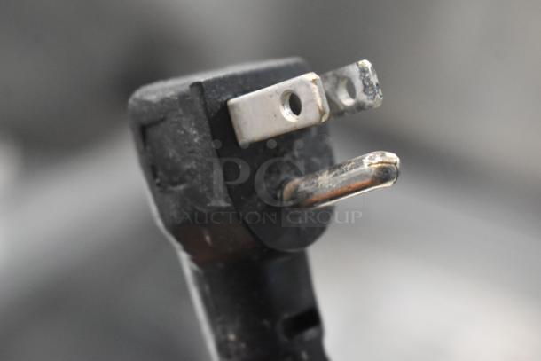 Close-up of a black electrical plug, likely for the 2016 Continental SW48-18M prep table, showing standard prongs.