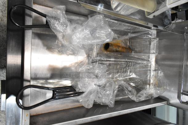 KUT50FRN50SNG stainless steel commercial fryer with two metal fry baskets, natural gas powered, shown with wrapped handles.