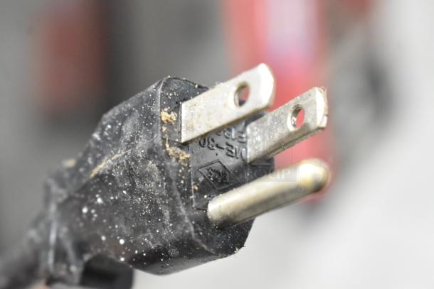 Close-up of a plug from the Bunn MHG Stainless Steel Commercial Coffee Bean Grinder, showing some wear and dirt.