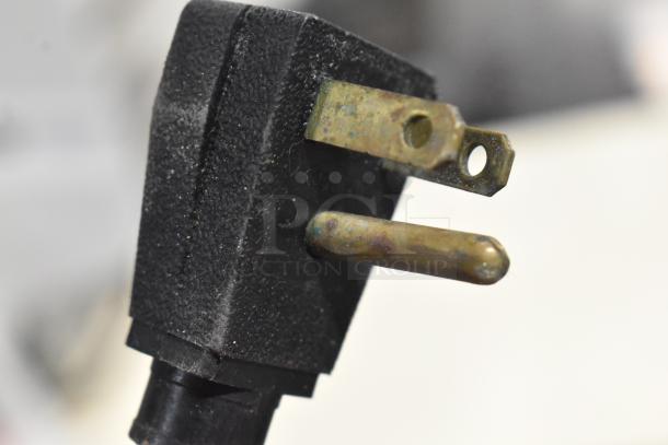 Close-up of a power plug for the Hoshizaki CRMR27-D undercounter cooler, showing prongs and worn condition.