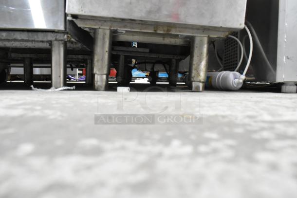 Stainless steel commercial deep fryer, Model KUT50FRN50SNG, natural gas, with 2 metal fry baskets; shows legs and wiring.