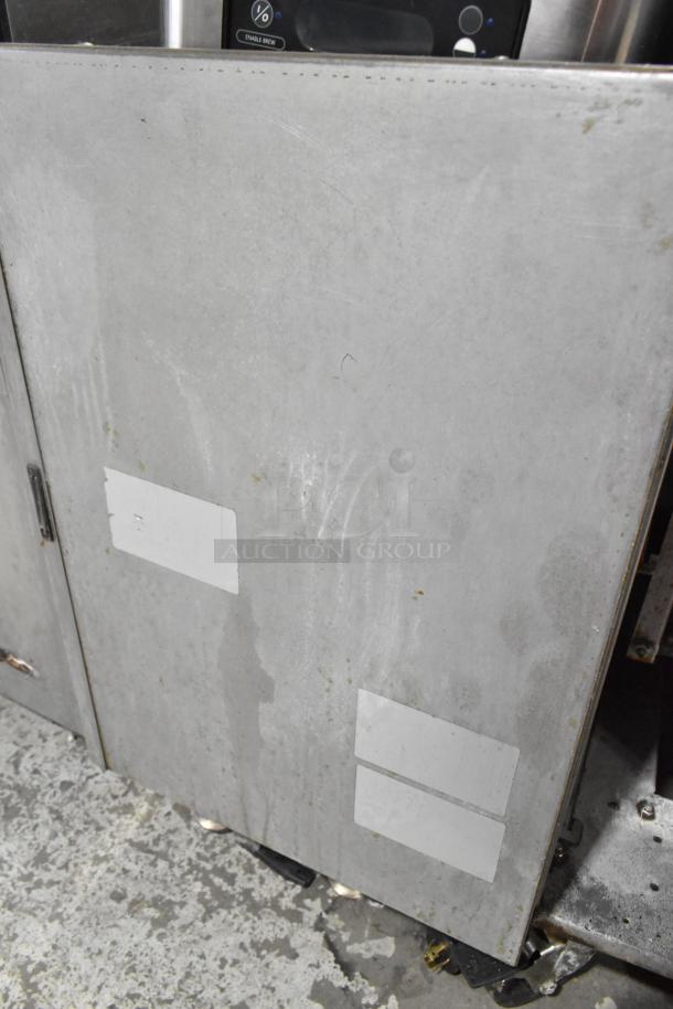 Royal stainless steel deep fat fryer with 2 metal fry baskets, on commercial casters. Visible wear; labels partially visible.