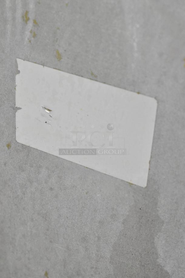 Royal stainless steel commercial deep fat fryer with 2 metal fry baskets, on casters; features unclear marking.