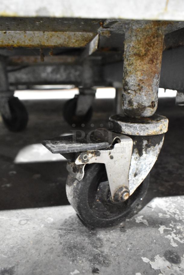 Royal stainless steel fryer caster, showing rust and wear, part of a commercial fryer with two metal baskets.