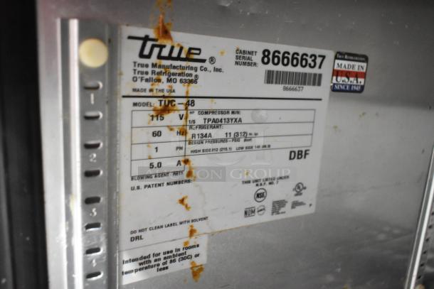 True TUC-48 stainless steel commercial cooler label. Includes model, 115 volts, refrigerant type, and manufacturing details.
