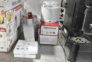 Robot Coupe R2N food processor with bowl, lid, continuous feed head, grater, slicer blades; 120V, 1 Phase.