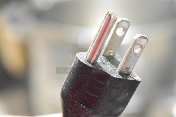 Robot Coupe R2N food processor power plug, showing a close-up of the three-prong configuration.