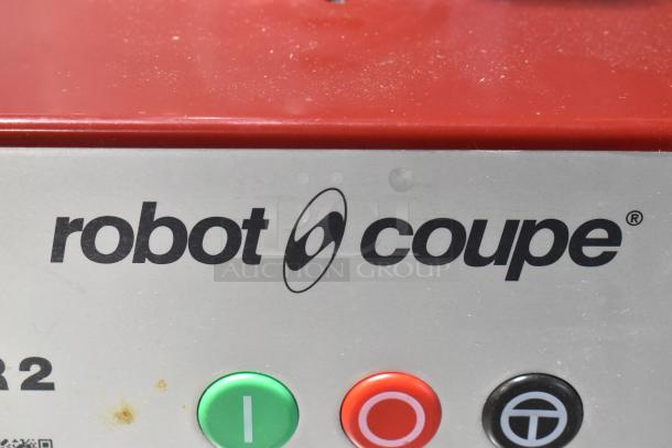 Robot Coupe R2N food processor, metal design, red top, visible controls, suitable for commercial use.