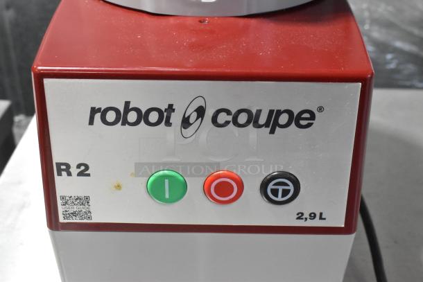 Robot Coupe R2N metal food processor features bowl, lid, continuous feed head, grater, slicing blades; 120V, 1 phase.