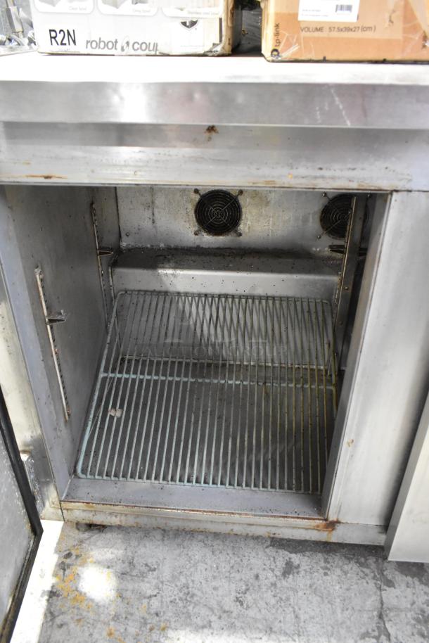 Leader NSFB 48 S/C 2-door stainless steel undercounter cooler; used condition; with commercial casters and interior shelving.