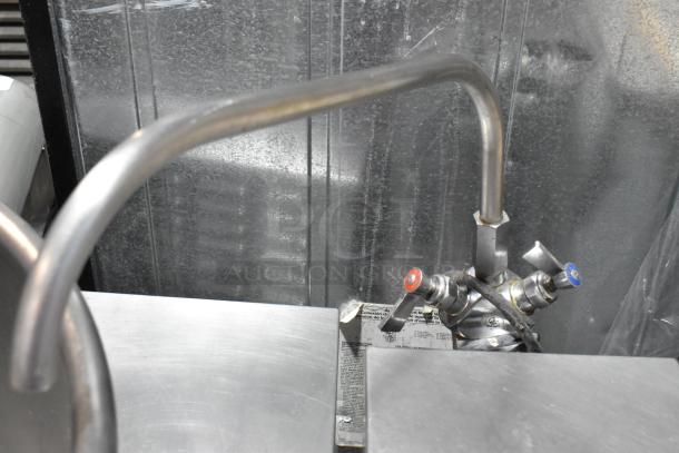 Cleveland stainless steel commercial floor-style tilting kettle, features dual controls for precise temperature adjustment.