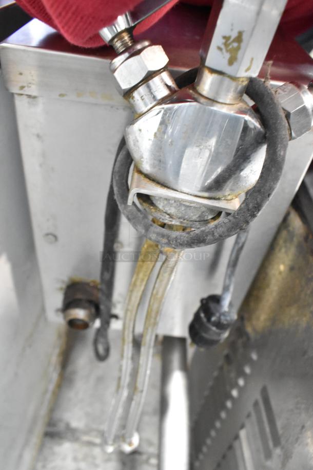 Cleveland stainless steel commercial tilting kettle, floor style. Features visible pipes and fittings, used condition.