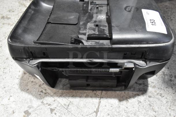 HP OfficeJet 3830 printer, showing the top view with visible wear and a labeled tag. Multifunction device includes scan, copy, fax.