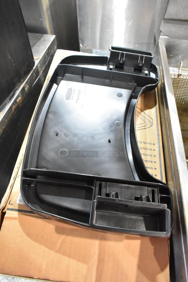 Brand new Rubbermaid FG781588 black high chair tray, durable plastic, with attachment slots.