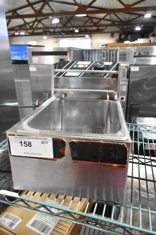 Stainless steel countertop electric deep fat fryer, 115 volts, 1 phase. Features control panel and visible wear on surface.