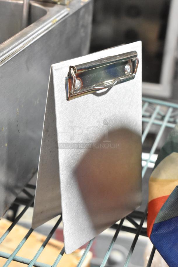 Aluminum standing clipboard menu holder, V-shaped design, in good condition, part of a mixed lot for auction.